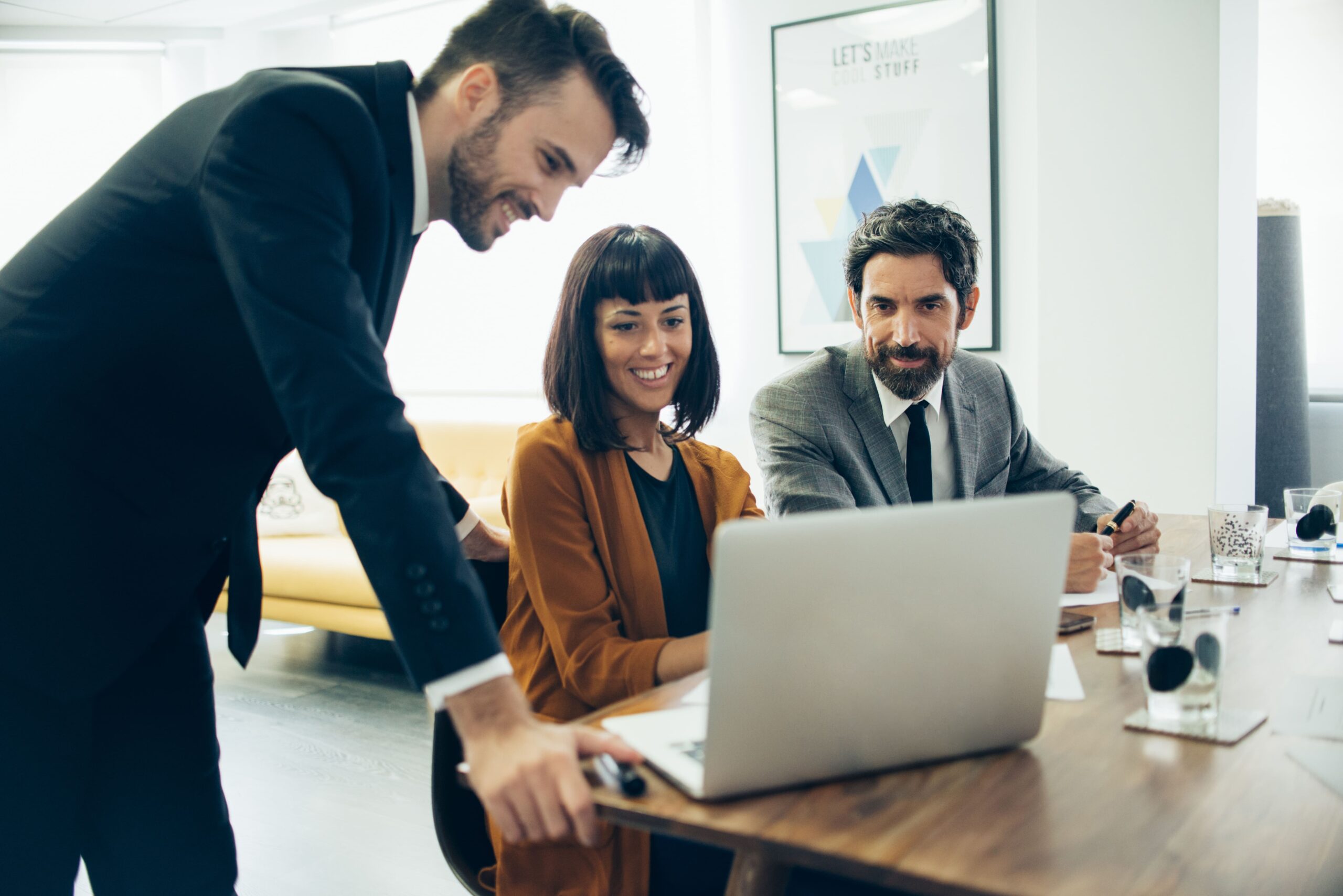 smiling-businesspeople-working-with-laptop (2) (1)